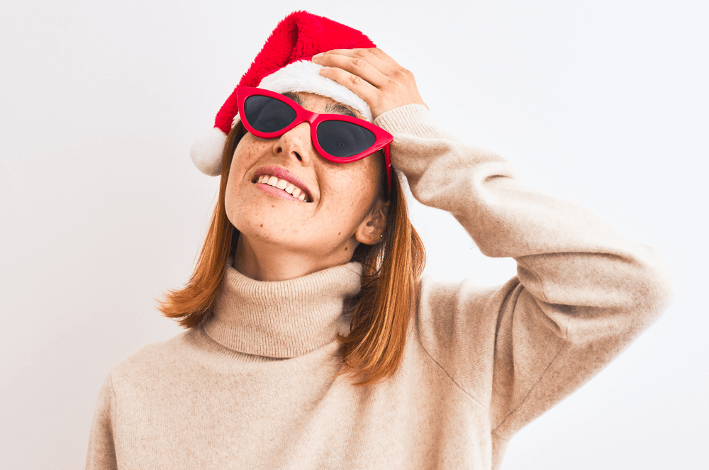 Woman wearing Santa hat and glasses