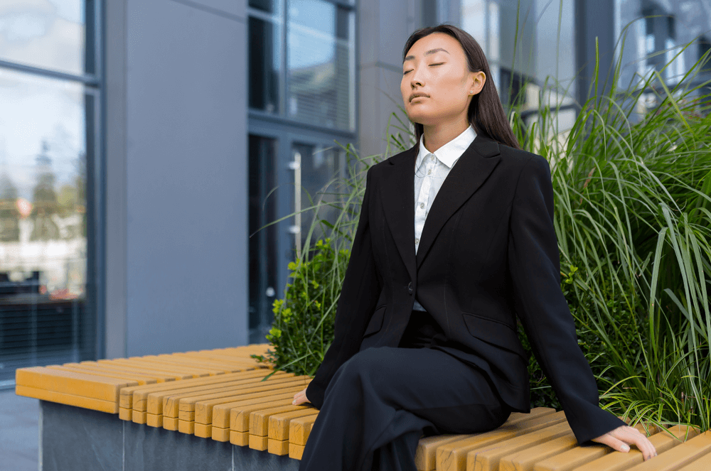 Woman sitting with eyes closed