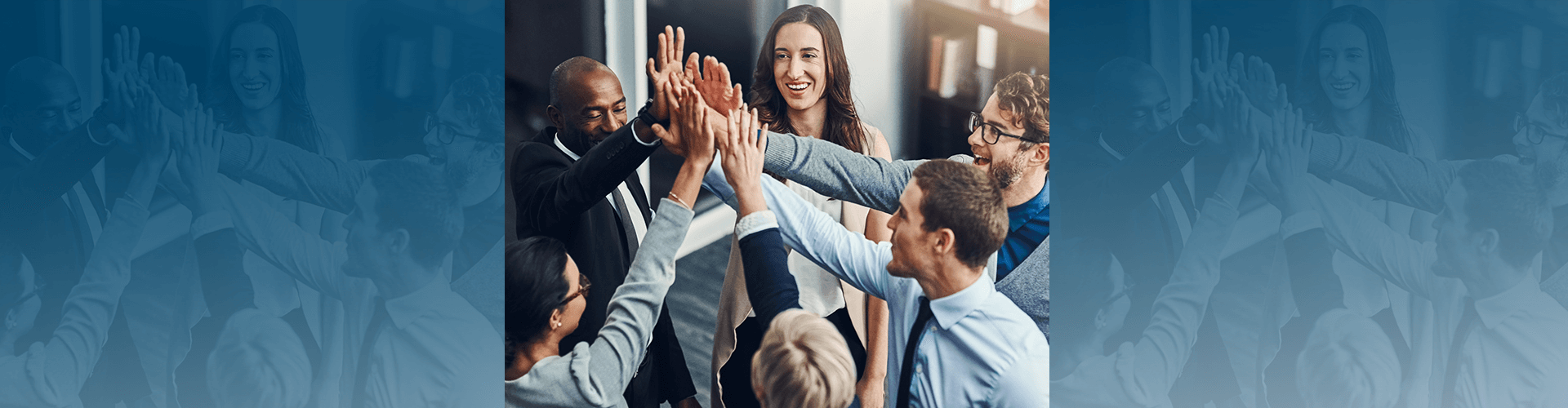 A group of people in a circle with hands in the air in the middle