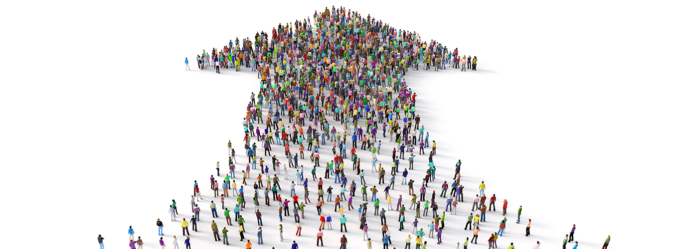 People in colorful shirts forming an arrow pointing up