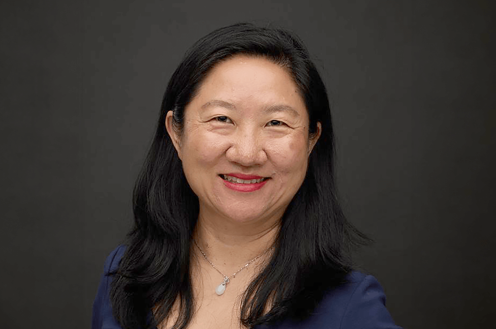 Woman in blue shirt smiling