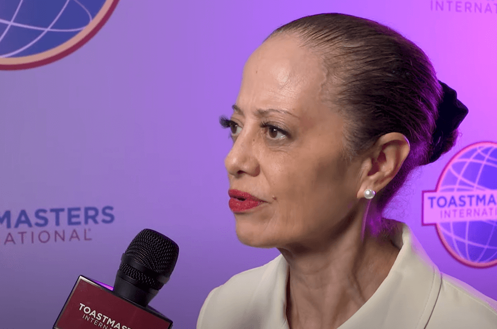 Woman speaking into microphone