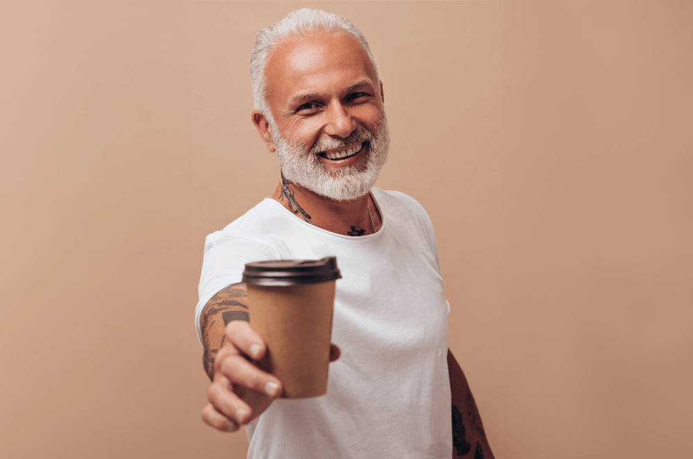 Man in white shirt holding a coffee