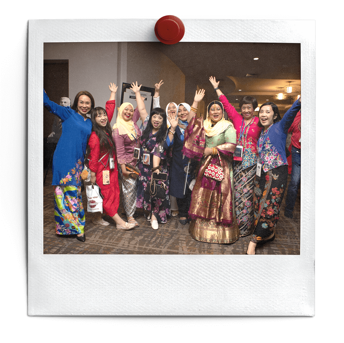Members show off their native attire and their enthusiasm for Toastmasters at the Global Celebration Reception.