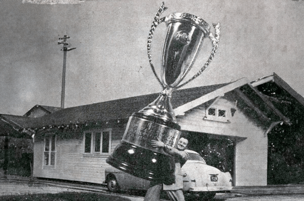 Dick Brooks of Westchester Toastmasters in Los Angeles shows off his Table Topics cup–which he proudly modified into this photo in a 1954 issue of The Toastmaster.