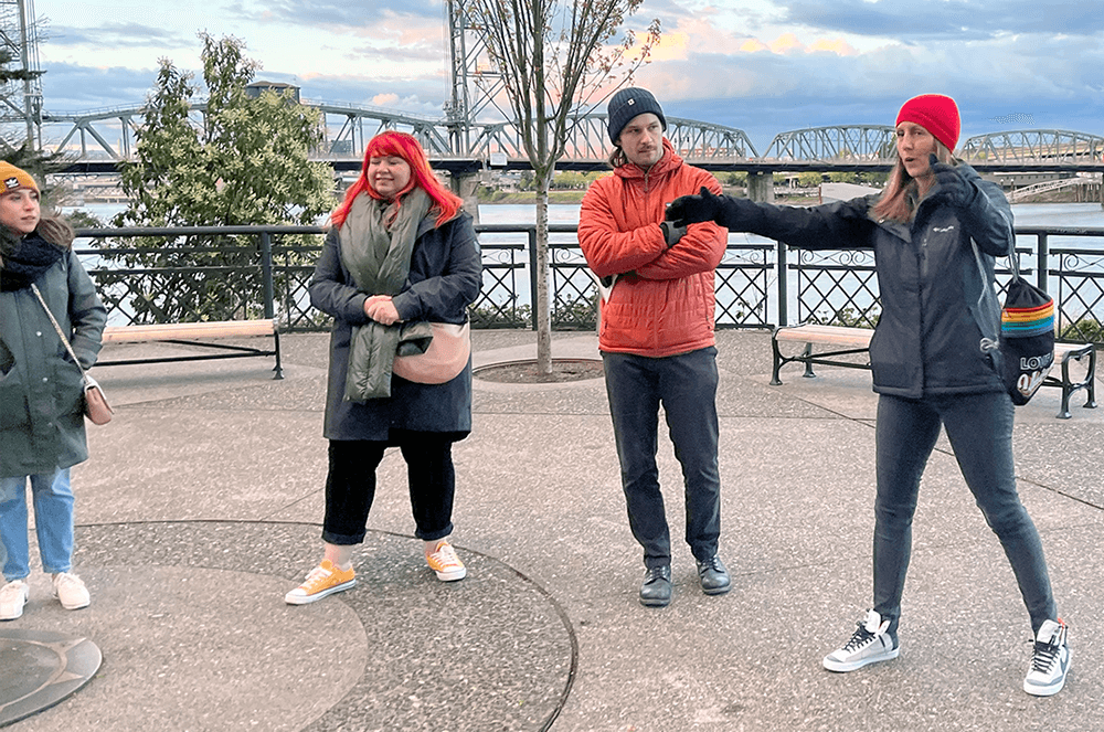 Three people in winter jackets standing outside