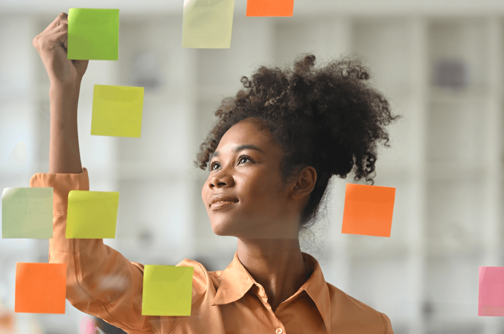 Woman writing on sticky notes