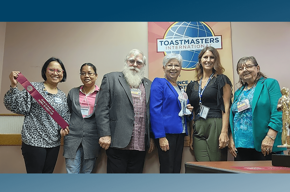 Dr. Ralph C. Smedley—in cutout form—visits members of the Prince
Albert Toastmasters Club #1318 in Prince Albert, Saskatchewan, Canada, during a visit with Area Director Linda Holmevik, DTM.