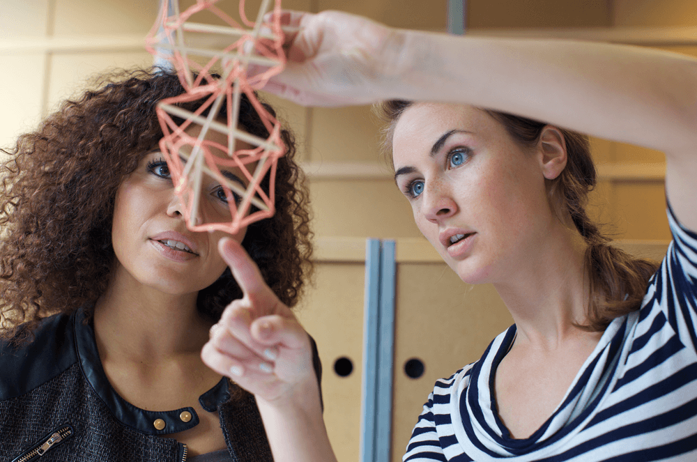 Two women looking at an object