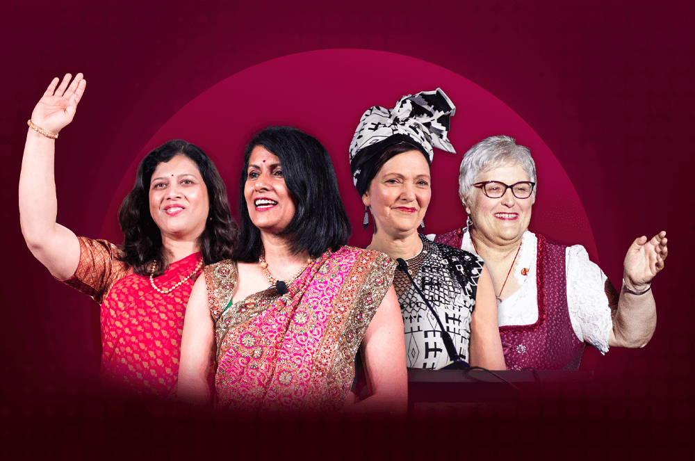 Four women in their native attire smiling