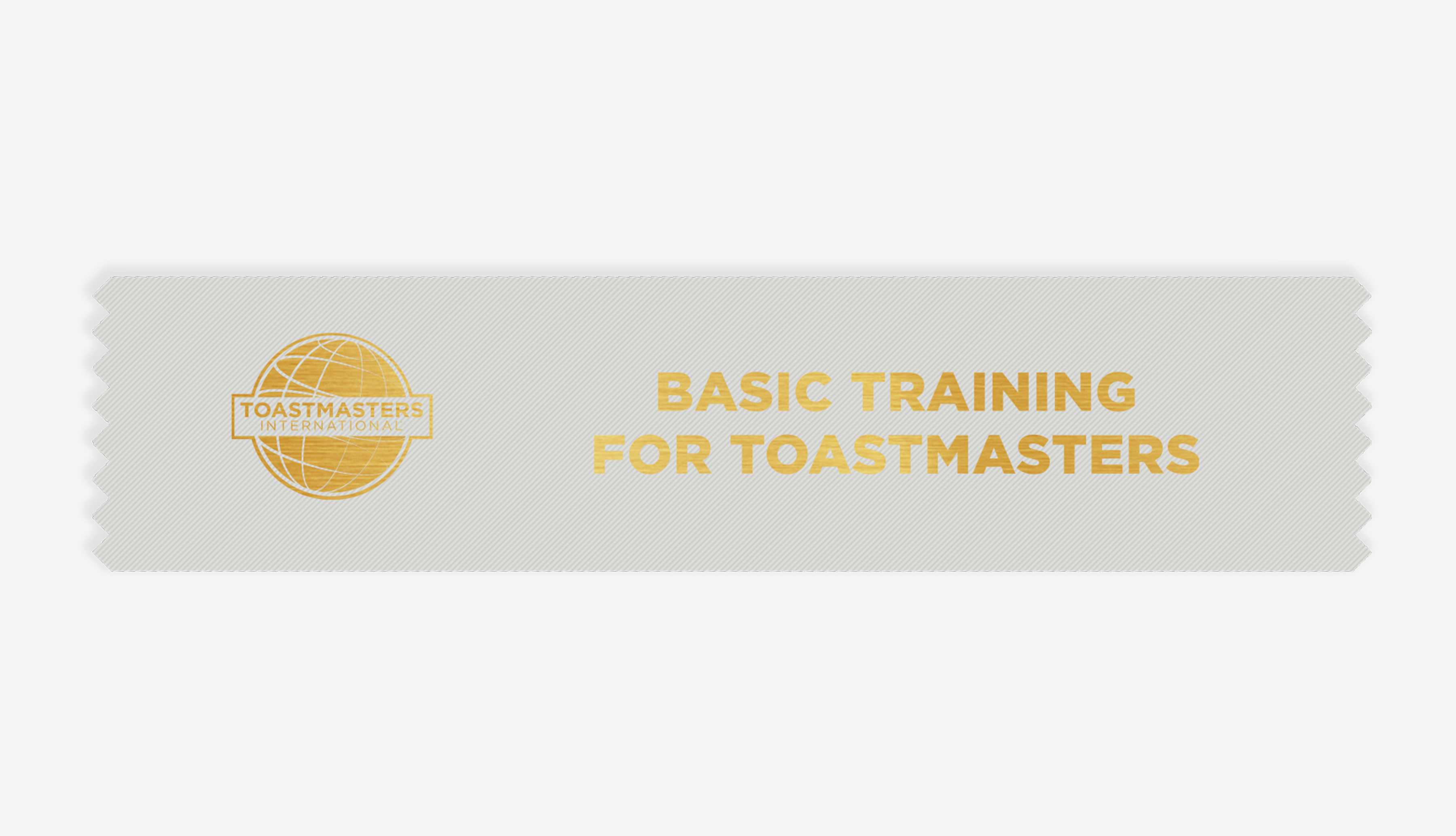 A silver-colored ribbon with a gold foil Toastmasters globe logo and the text 