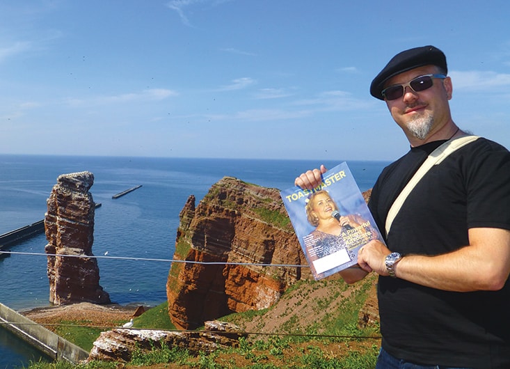 Marcus Gadient, from Basel, Switzerland, visits Helgoland, Germany, to see the rock formation, Lange Anna, pictured in the background.