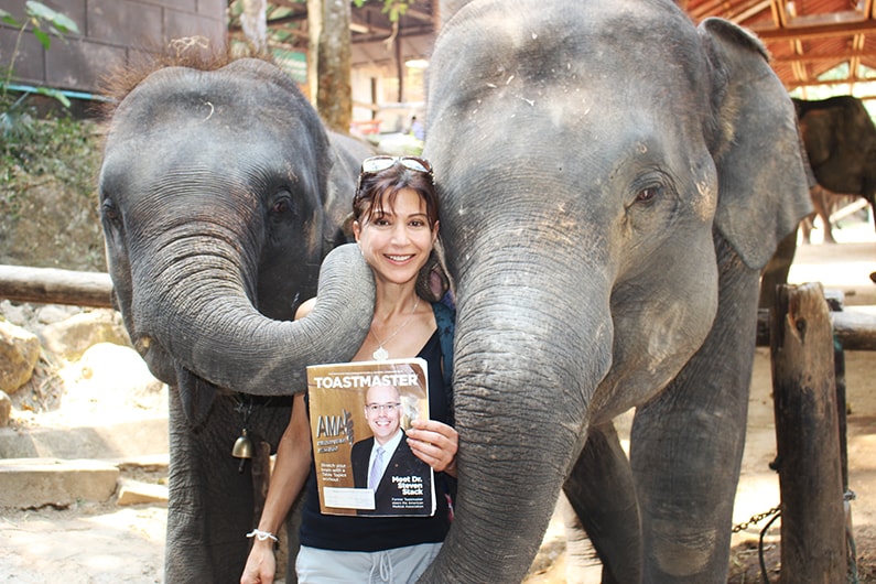 Elizabeth Borelli, from Los Gatos, California, gets cozy with the elephants in Chiang Mai, Thailand.