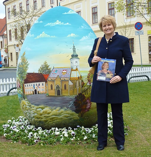 Vesna Kavaz, from Athabasca, Alberta, Canada, stands in front of a hand-painted Easter egg on display in Zagreb, Croatia. 