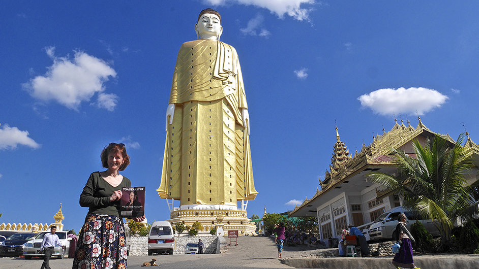 Colleen Shaughnessy-Larsson, DTM, from Paris, France, poses near Laykyun Setkyar Standing Buddha in Myanmar. 