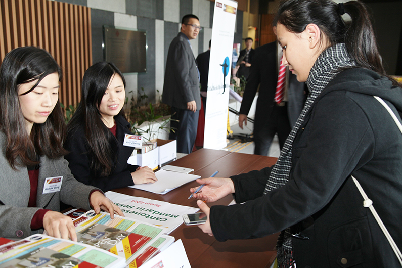 A guest signs in for the “Open Day” event put on by members of District 89 in Hong Kong.