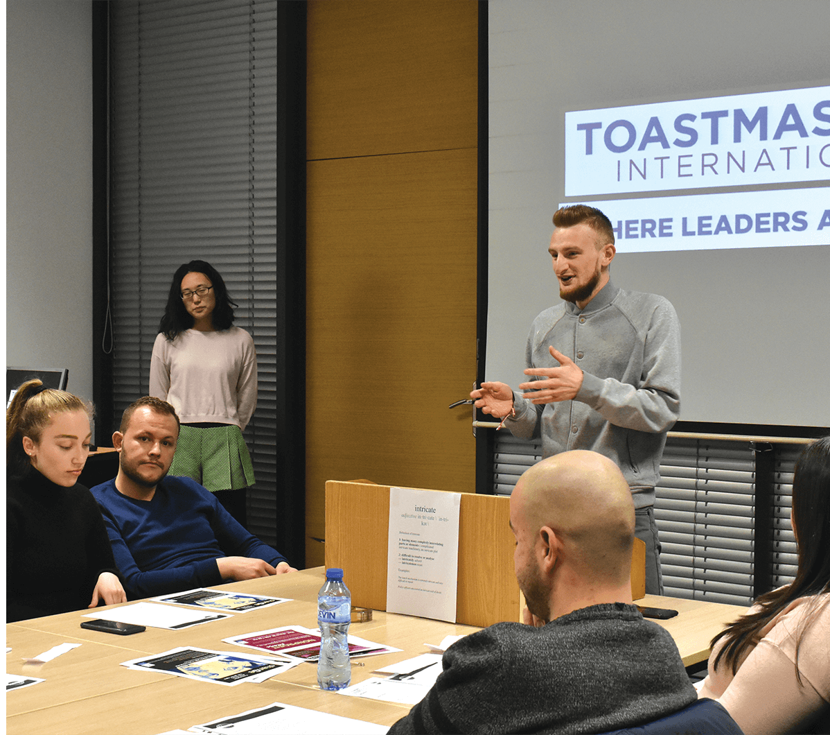 Man speaking at a club meeting