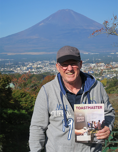 Edgar Niklaus, DTM, from Munich, Germany, poses while on vacation in Japan with Mount Fuji in the distance.