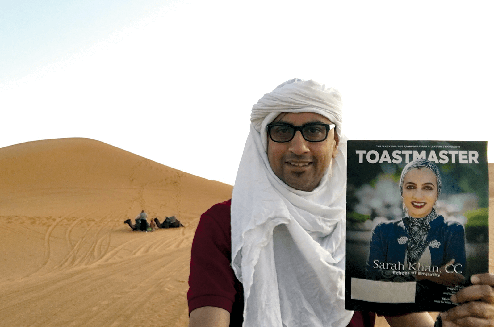 Jim Hussein, ACB, ALB, of Sydney, Australia, endures the brutal sun of the Sahara Desert in front of camels in Morocco, North Africa.