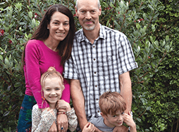 Priscilla Dickinson, husband, young daughter, young son posing outside