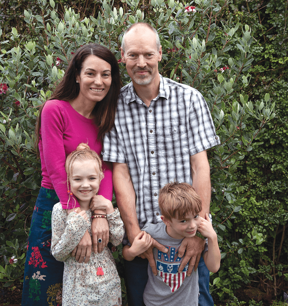 Priscilla Dickinson, husband, young daughter, young son posing outside