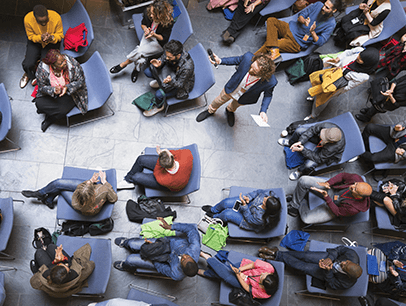 Man holding microphone around crow of people