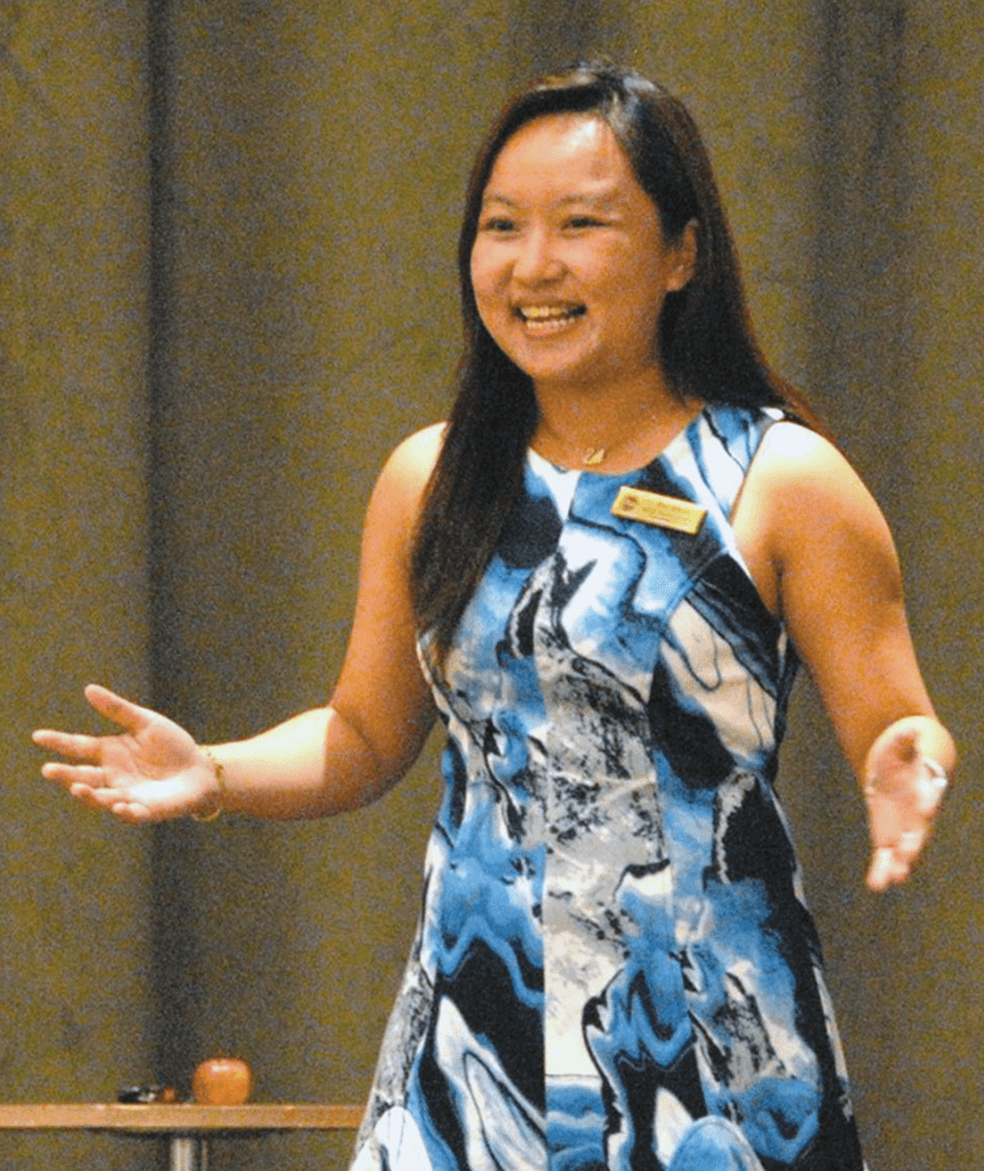 Jessica Chai Pei Shan gestures onstage while giving a speech