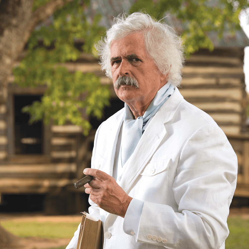 Man in white jacket dressed as Mark Twain impersonater