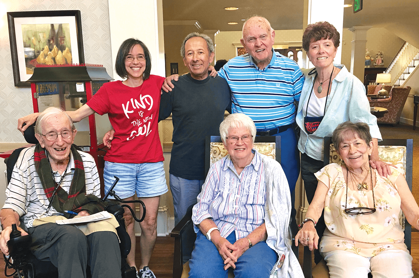 Senior citizens pose with Toastmasters volunteer