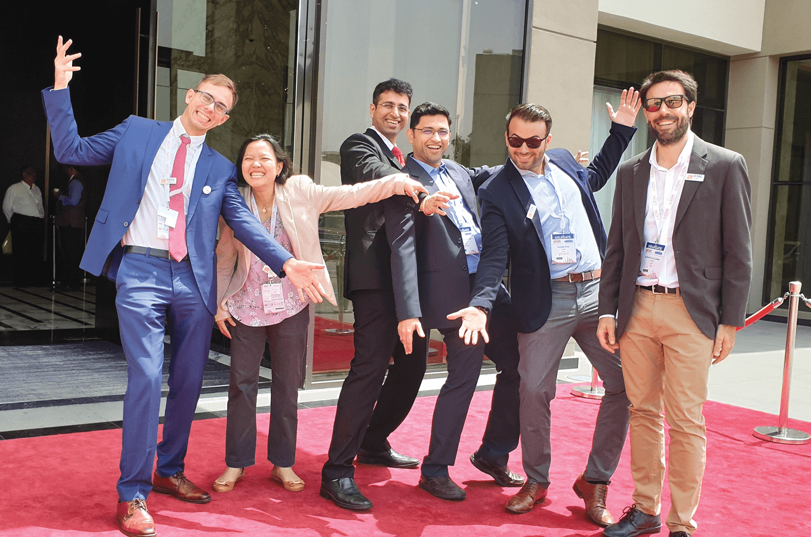 Group of 6 members pose on red carpet