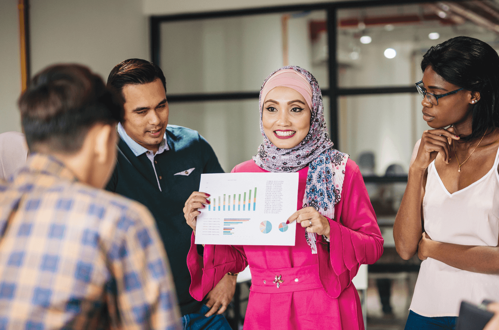 Woman holding work document while others look on