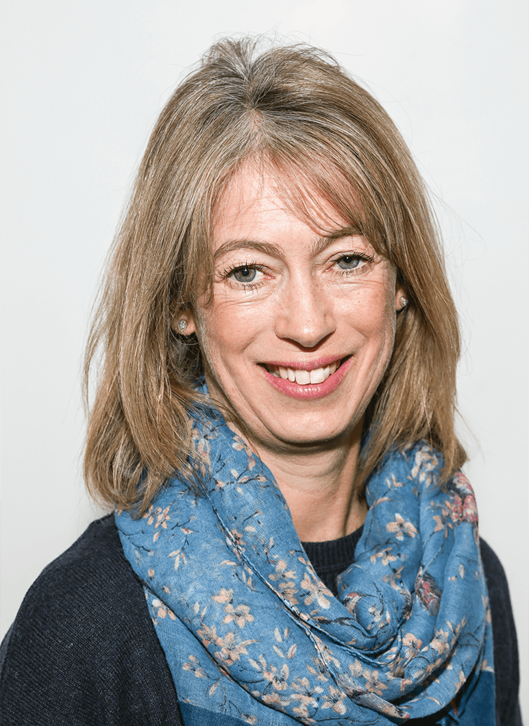 Woman smiling wearing blue scarf