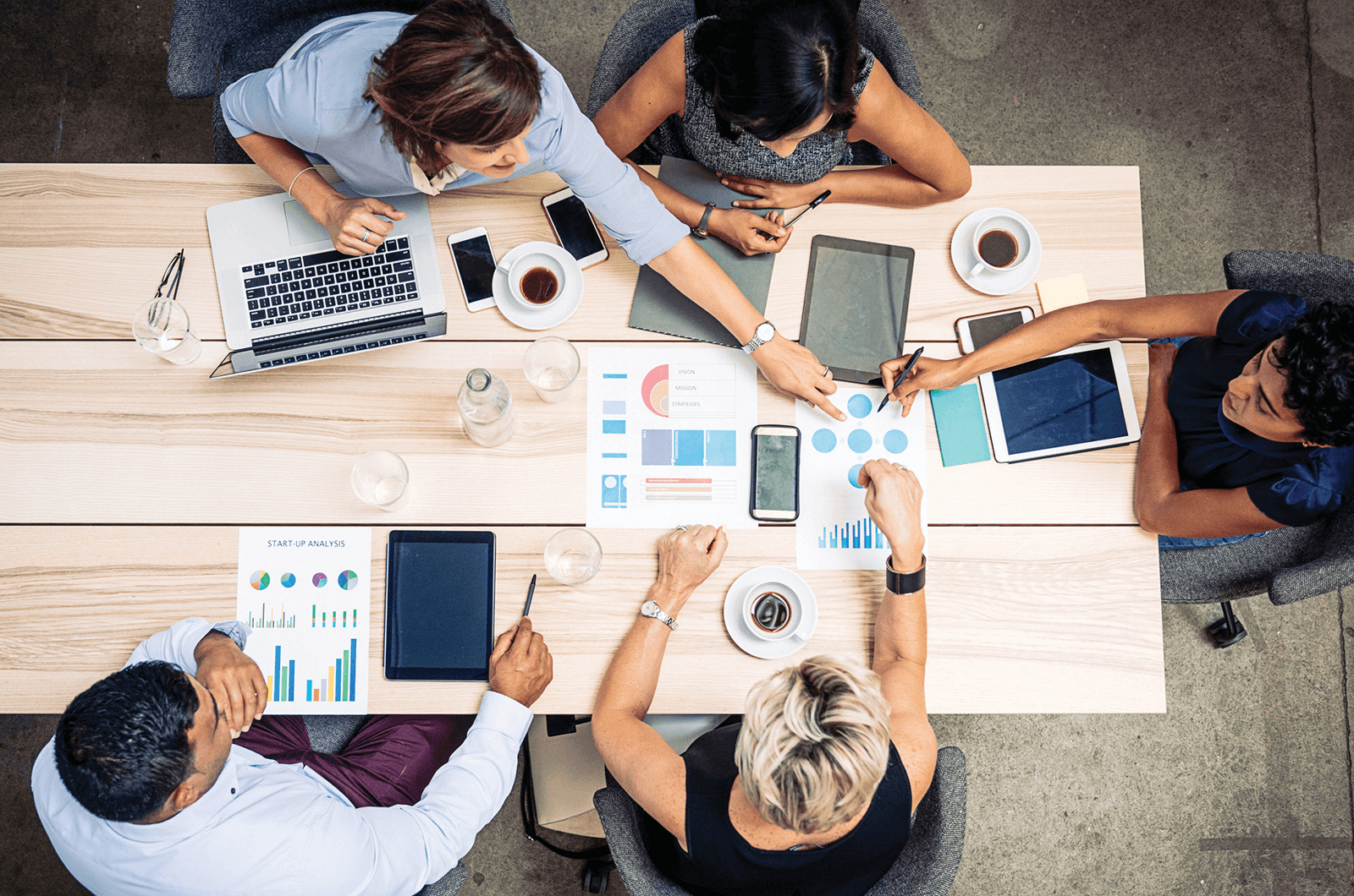 Co-workers at desk making decision