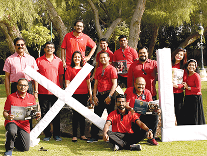 Group of Toastmasters members holding large letters