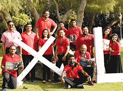 Group of Toastmasters members holding large letters