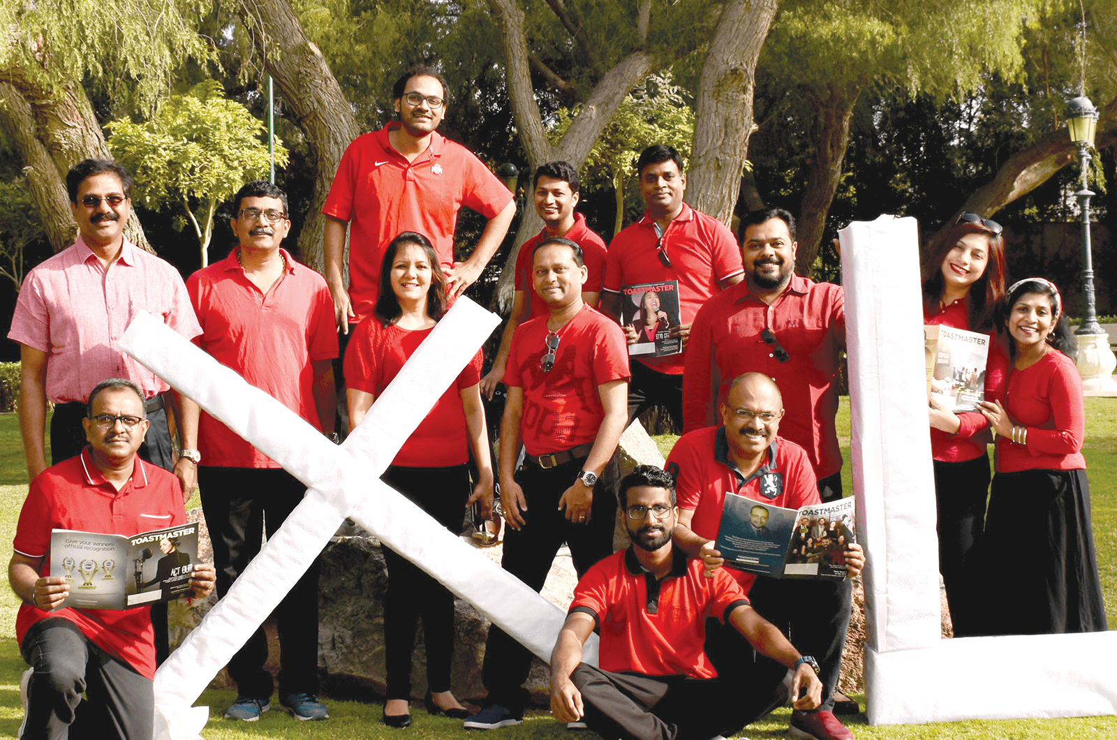 Group of Toastmasters members holding large letters