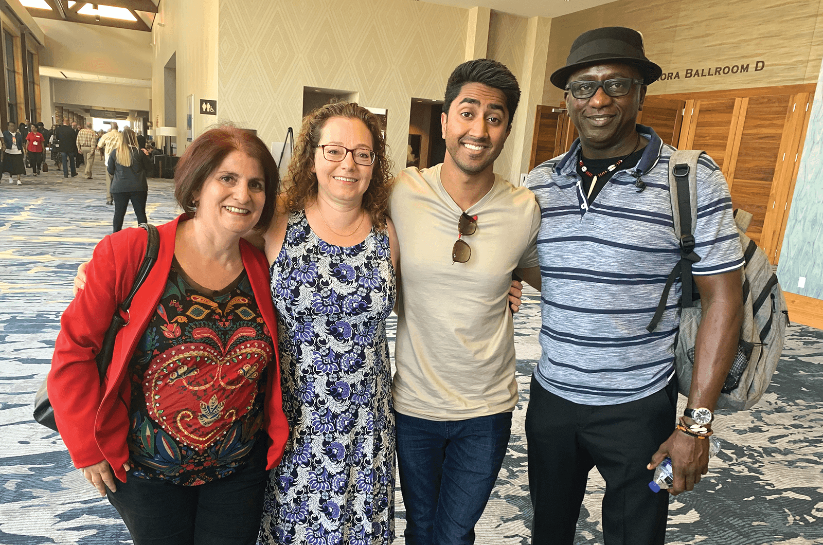 Four people pose together at annual convention