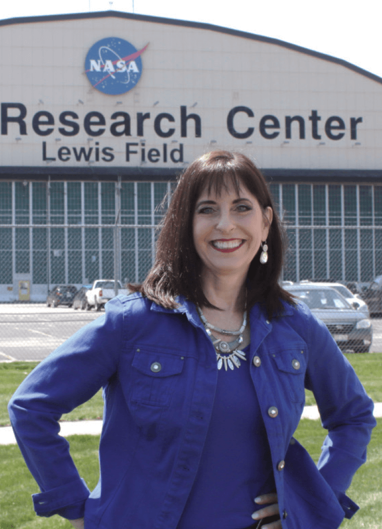 Woman in blue jacket standing in front of NASA building