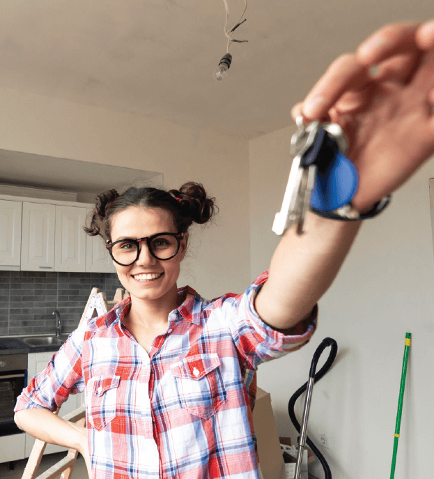 Woman holding keys to apartment