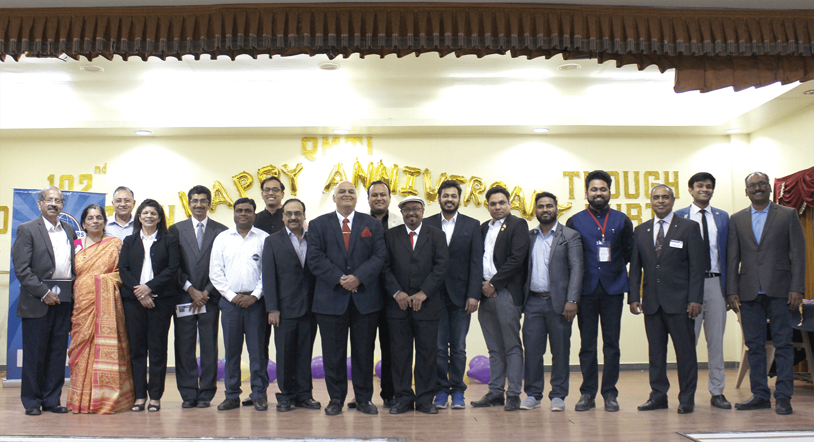 Toastmasters club members standing and smiling