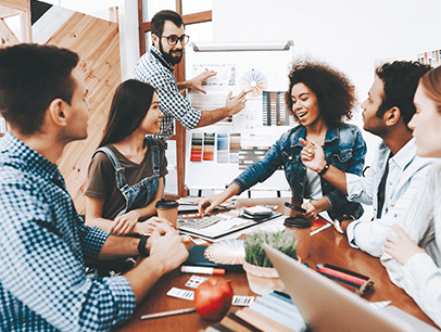 Six people sitting at a desk brainstorming