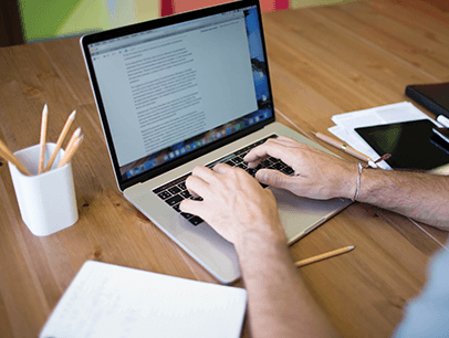 Someone typing on a laptop