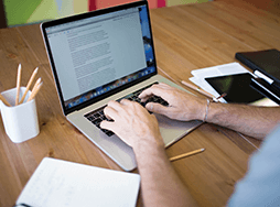 Someone typing on a laptop