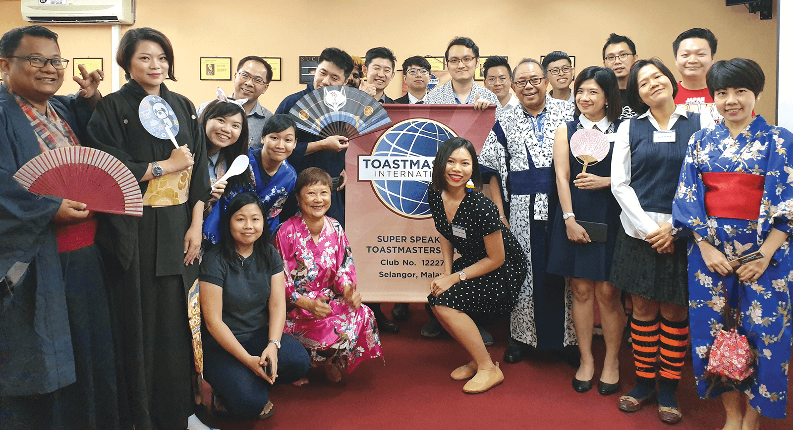 Club members in Malaysia pose with banner