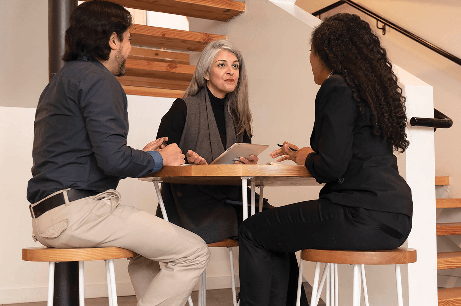 Three people sitting and having a discussion