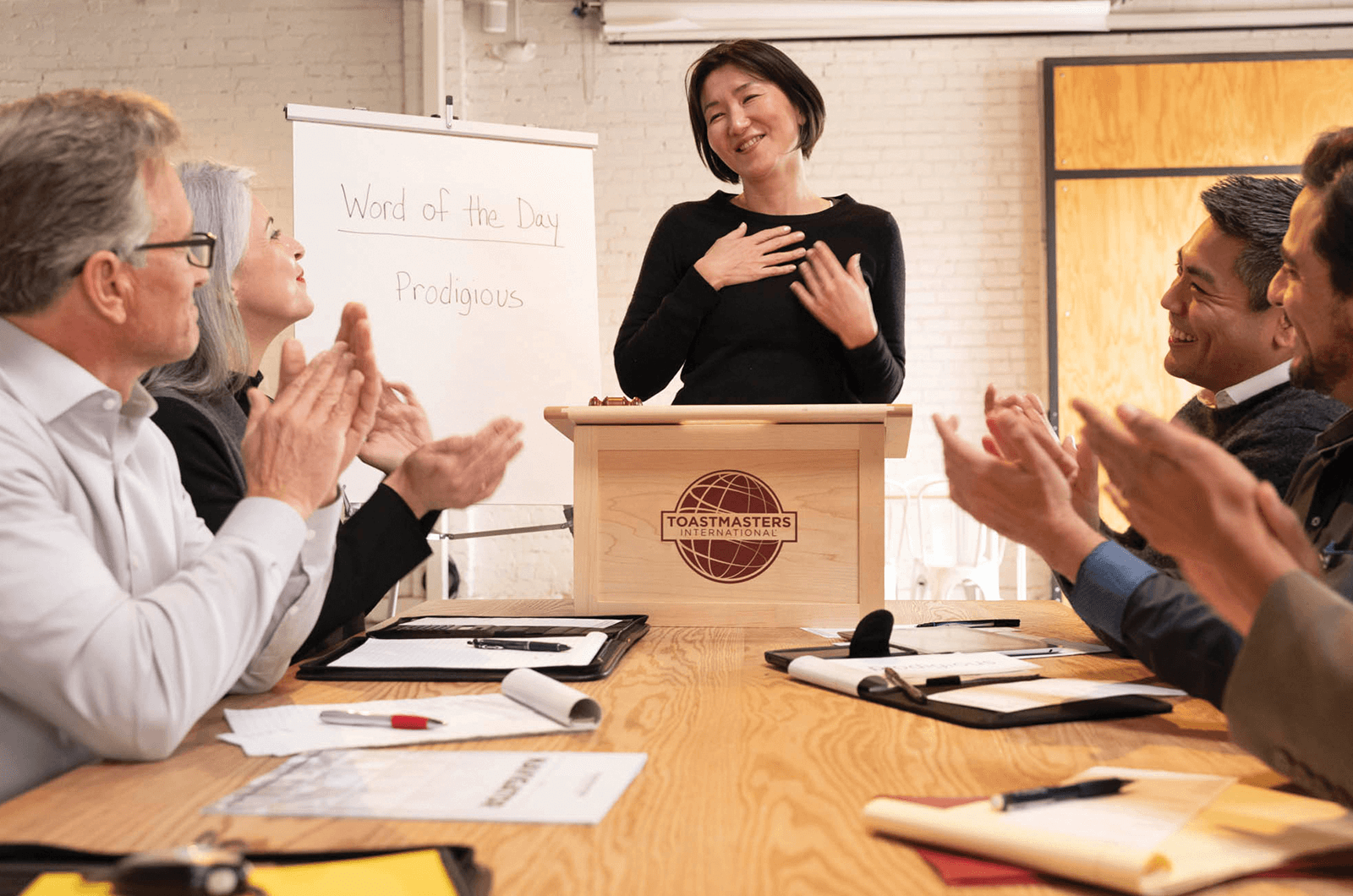 Woman standing at lectern smiling