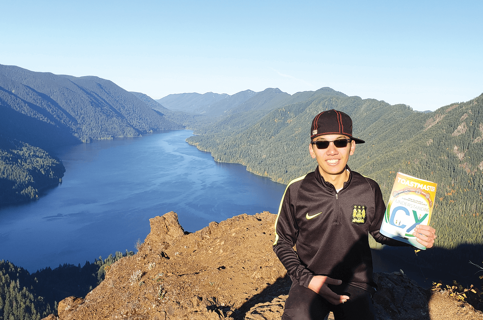 Cyrus Chan of Queens, New York, completes the Mount Storm King hike and looks over Lake Crescent near Port Angeles, Washington.