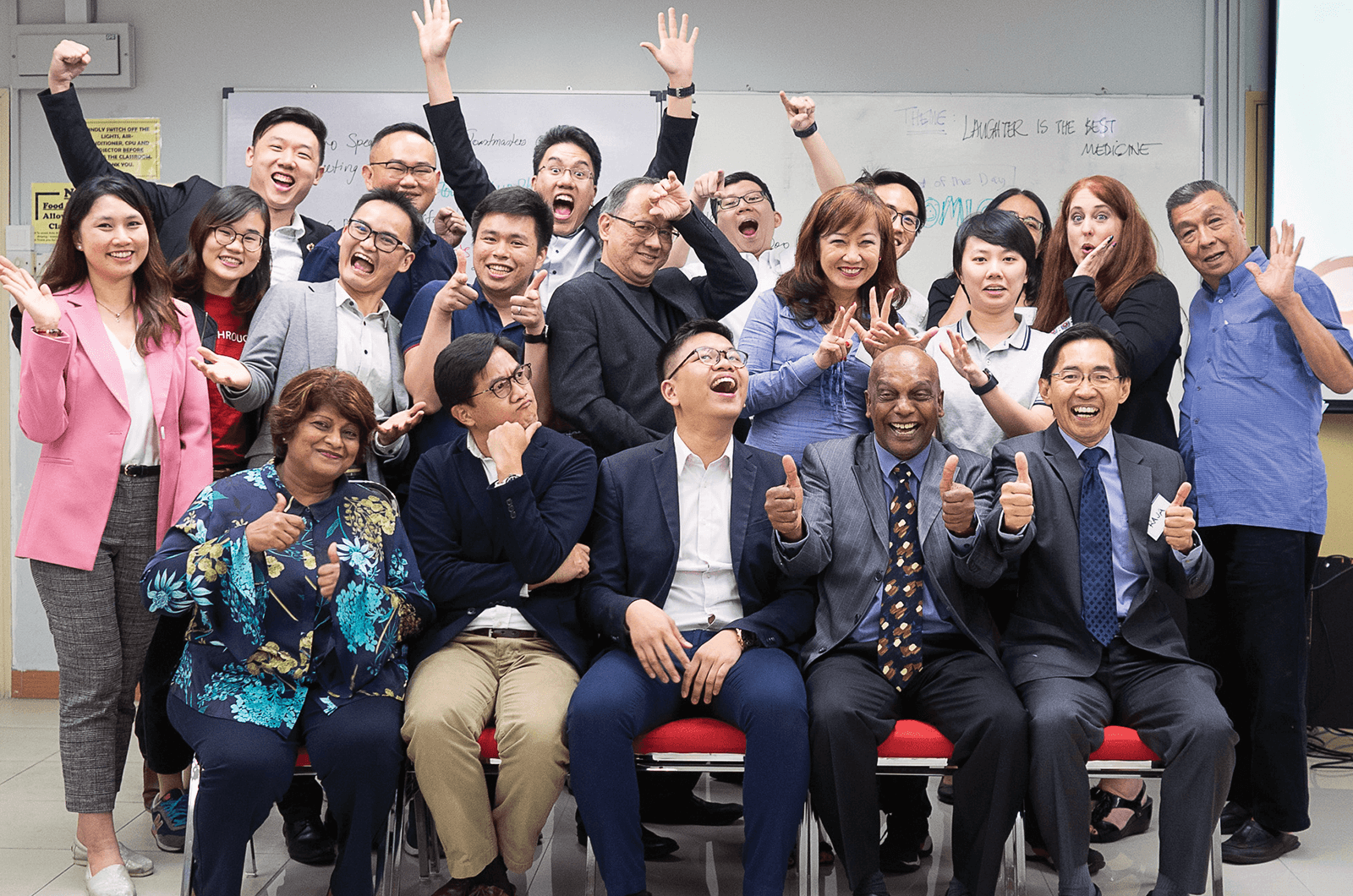 Group of Toastmasters with their hands in the air