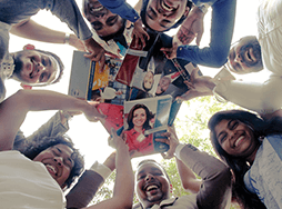Toastmasters members looking down at camera holding manuals