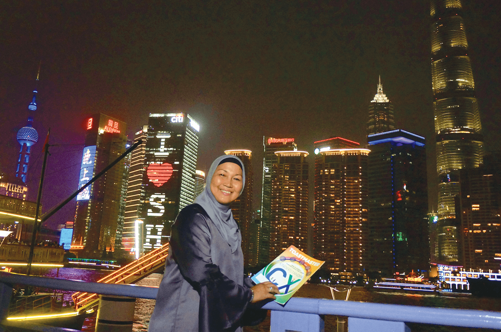 Julia Taha of Selangor, Malaysia, strolls along the Bund waterfront in Shanghai, China, and takes in the night scene, including the landmark Pearl TV Tower, lit in blue.